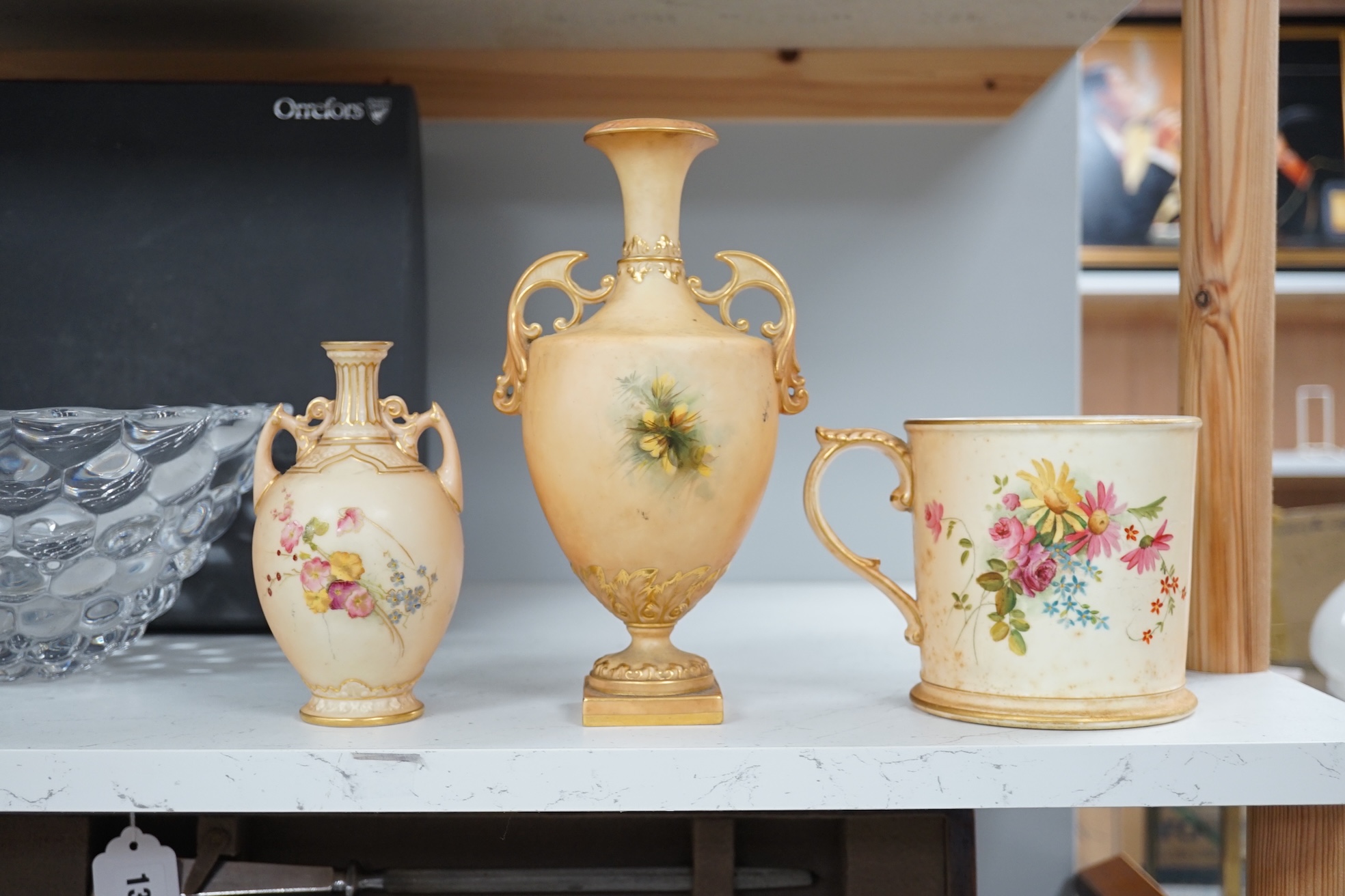 Three pieces of Royal Worcester; a mug, 11.5cm high, and two vases, tallest 22.5cm. Condition - good.